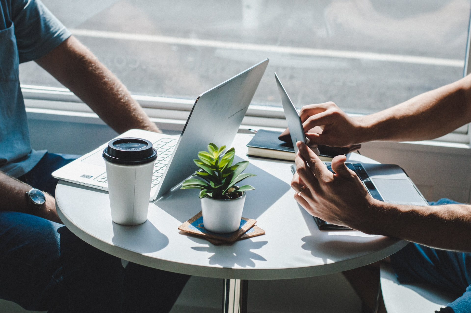 two person with a laptop on a table